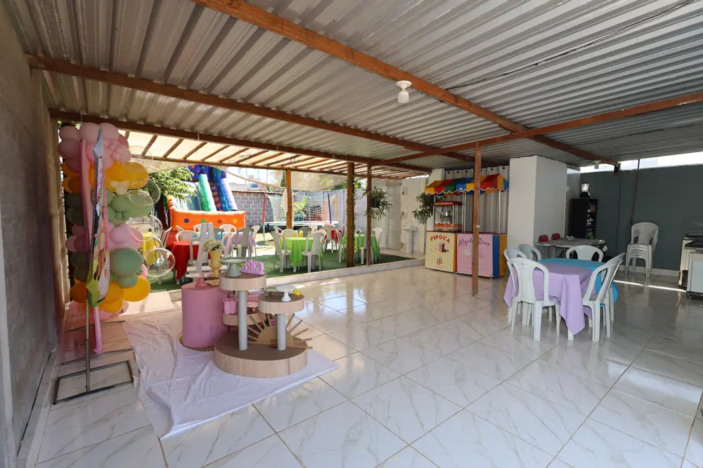 Salão interno do espaço, com decoração de uma festa em tons pastel